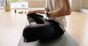 “A serene yoga pose in a calming home environment, highlighting how gentle movements can rejuvenate you beyond the clinic.