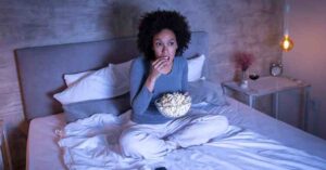 A cozy living room with popcorn and a movie screen, showing how to relax and enjoy yourself beyond the clinic