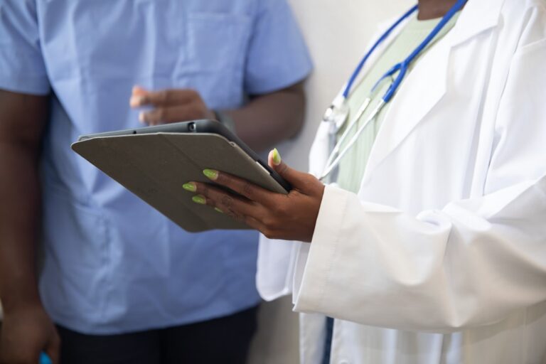Doctor reviewing a care plan on a tablet with a patient