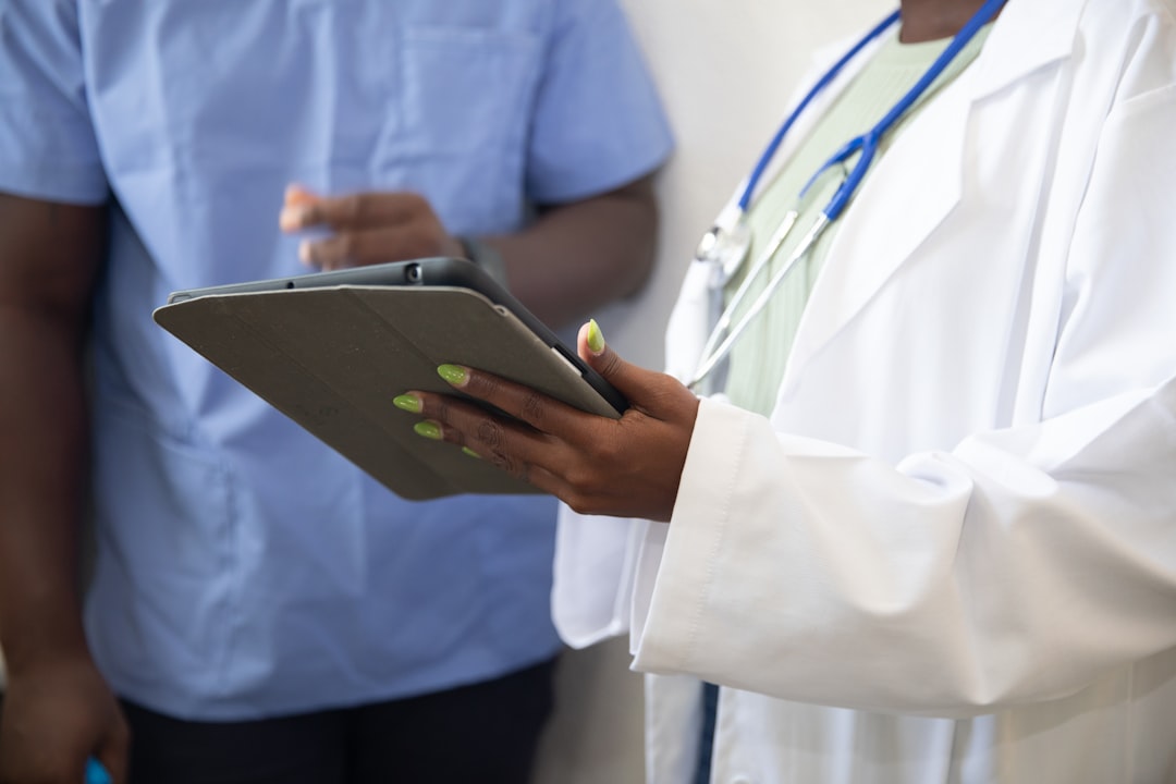 Doctor reviewing a care plan on a tablet with a patient